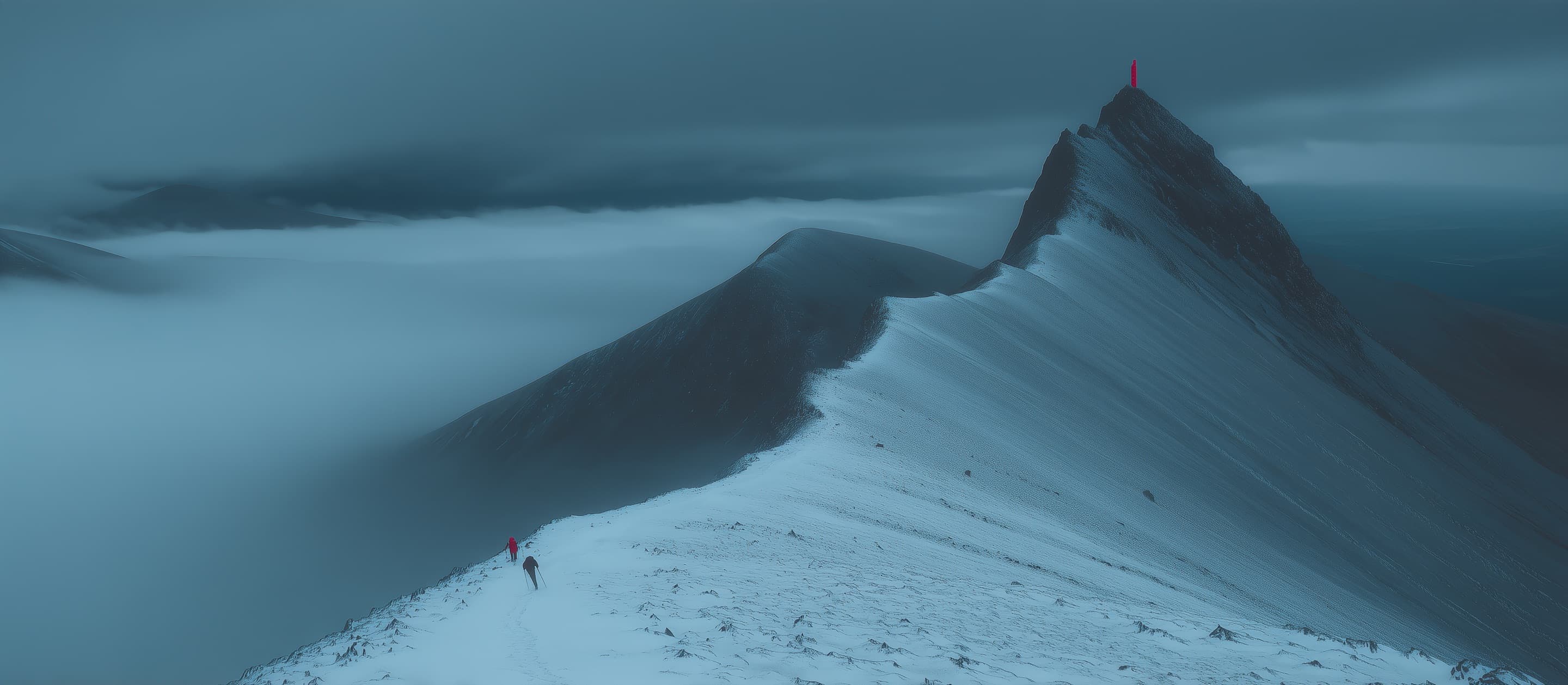 Two climbers on a snow ridge above a sea of fog, heading for a red beacon on the summit