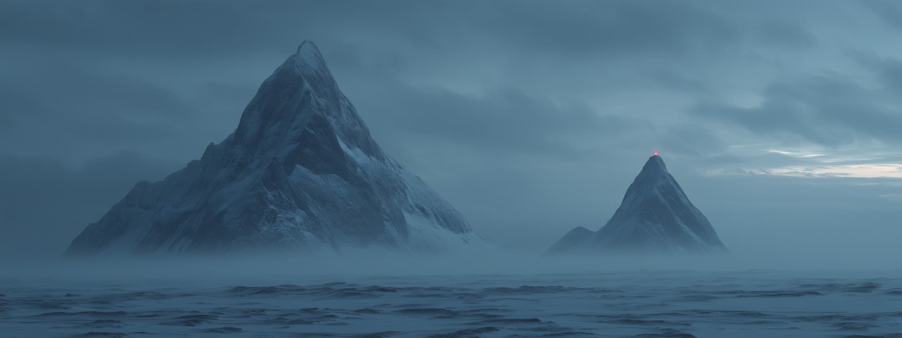 A broad, crowded summit and a lone sharp summit with a red beacon, rising above fog